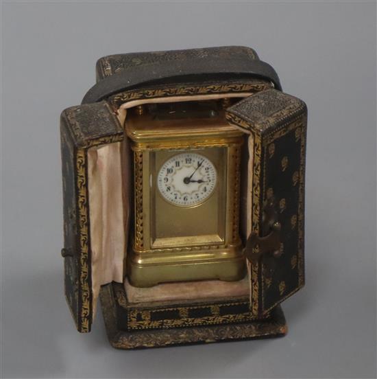 A miniature carriage timepiece, leather cased